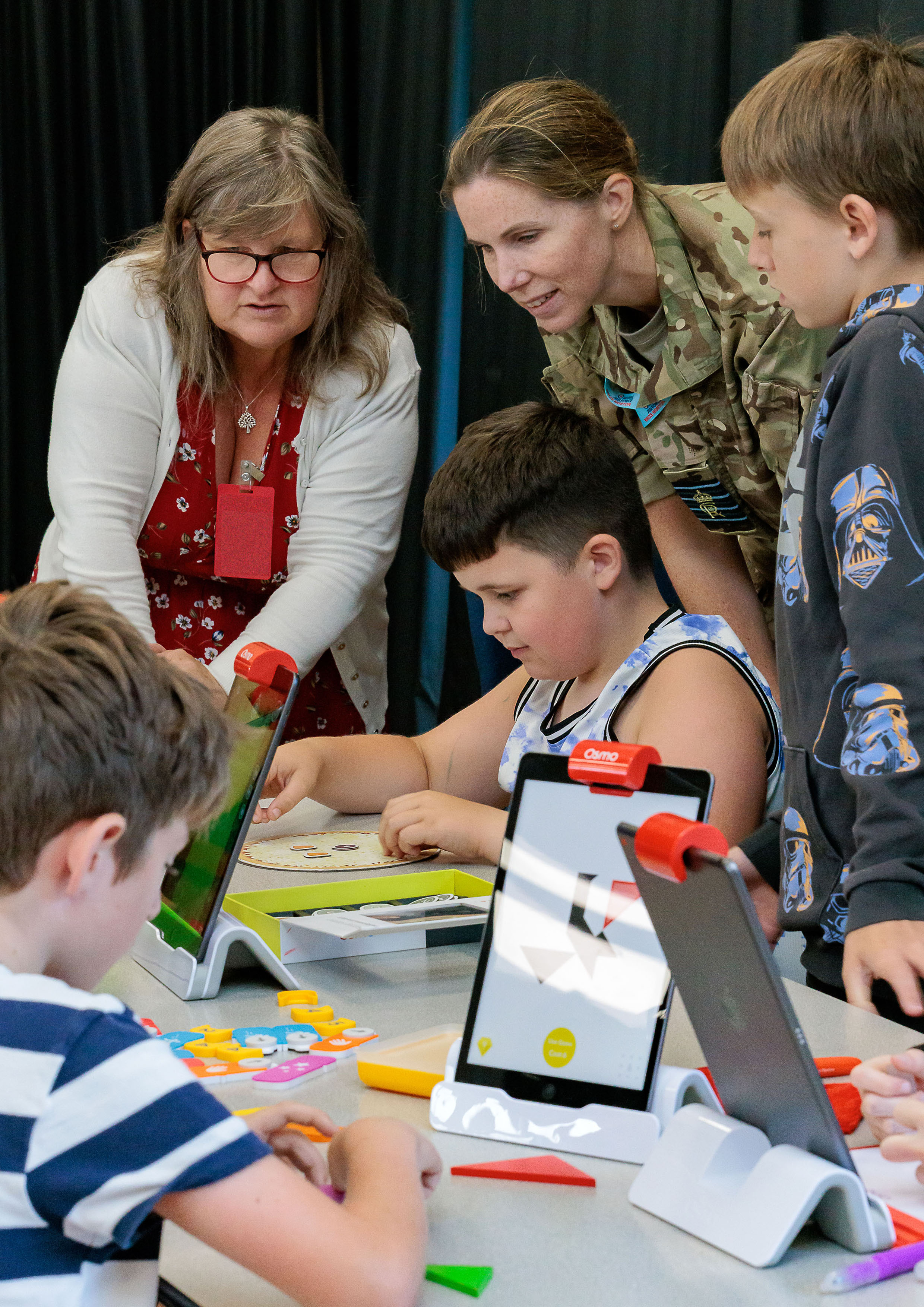 Photo: Royal Air Force Brize Norton Station Commander, Group Captain Louise Henton and a STEM ambassador, with a group of students who are engaged in STEM activities.